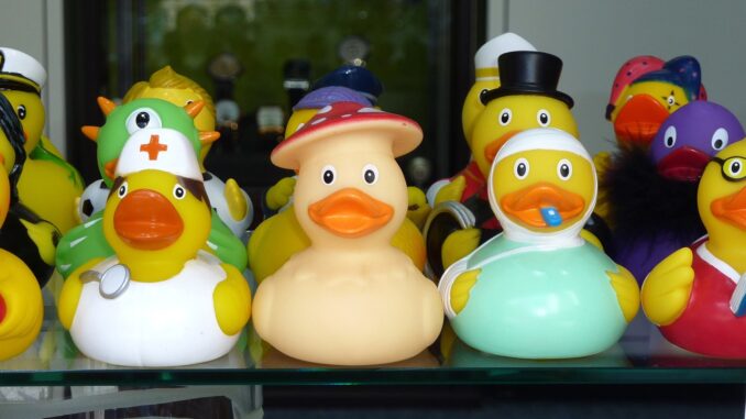 Row of rubber ducks in different hats