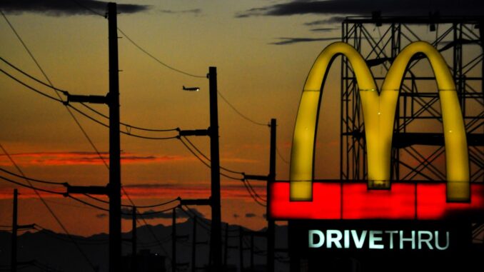 Image of McDonalds drive through sign at night